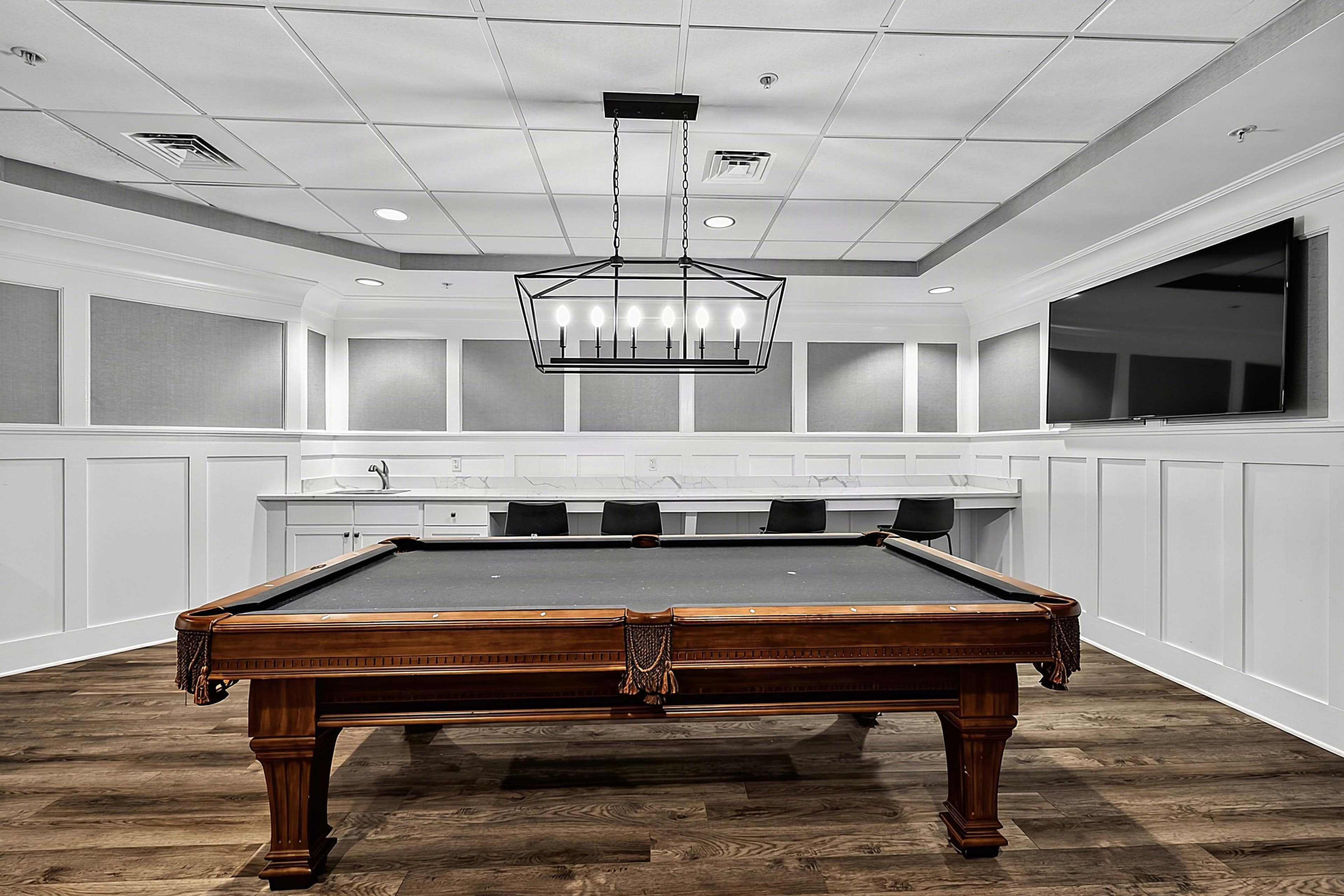 Front view of the billiards table and overhead light