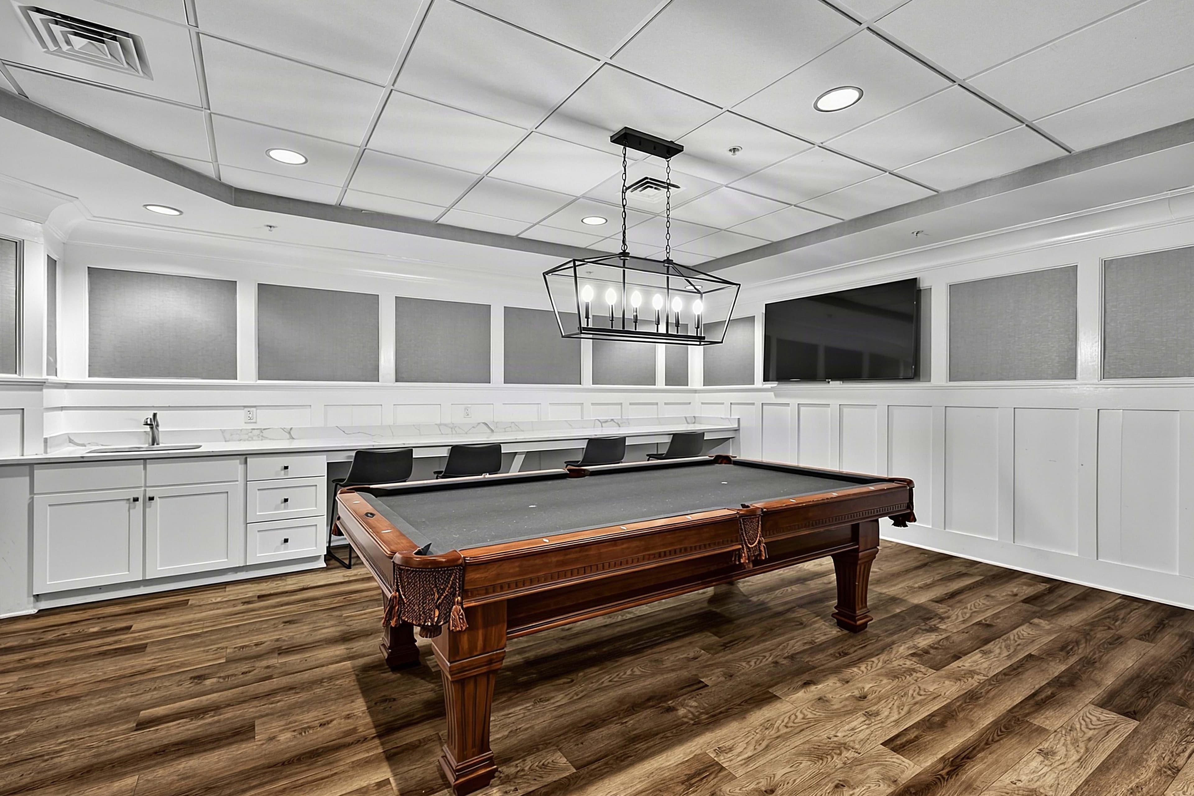 Angled view of the billiards table and built-in cabinets