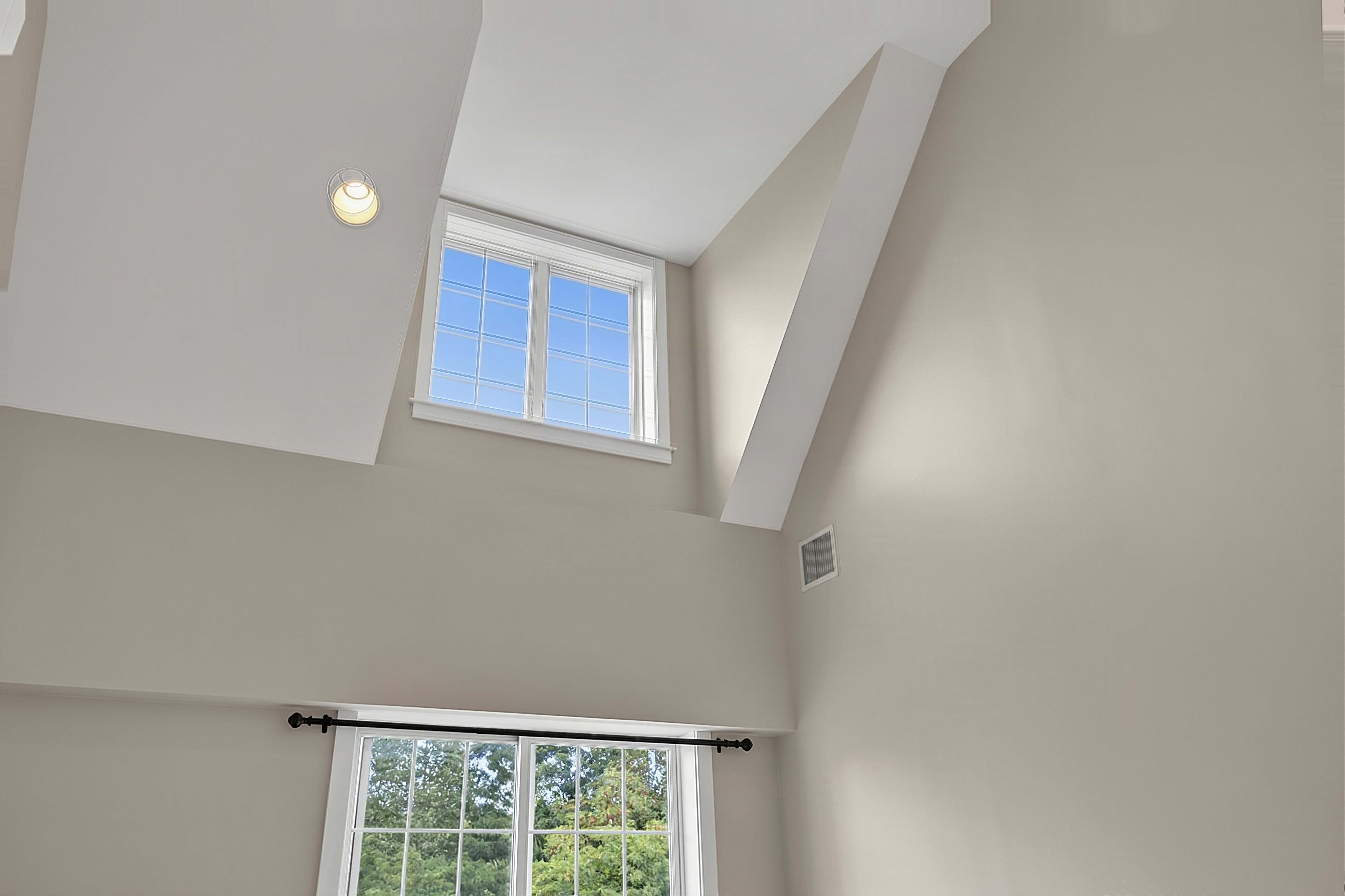 High windows bringing daylight into the double-height living room