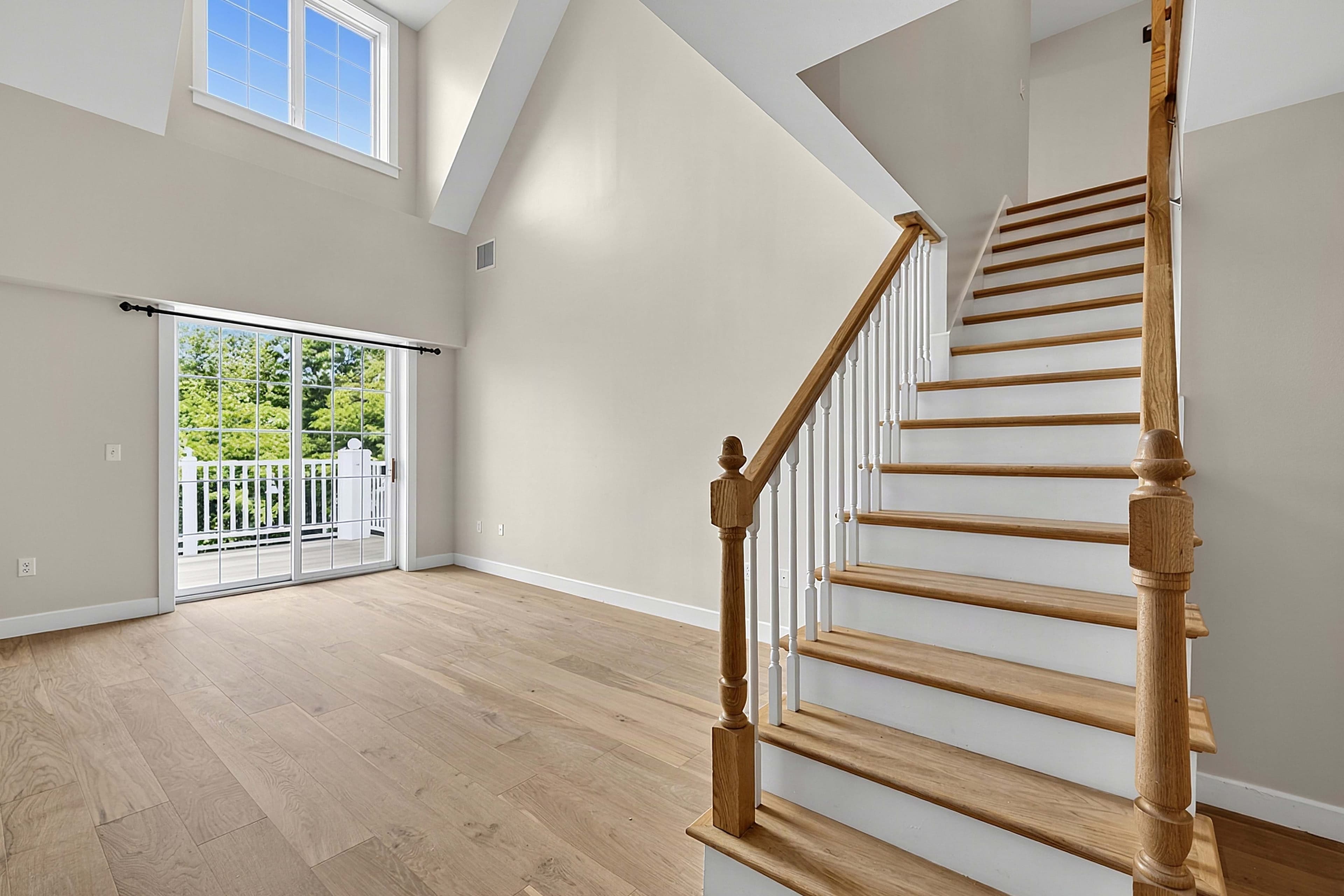 Living room beside the staircase and balcony doors