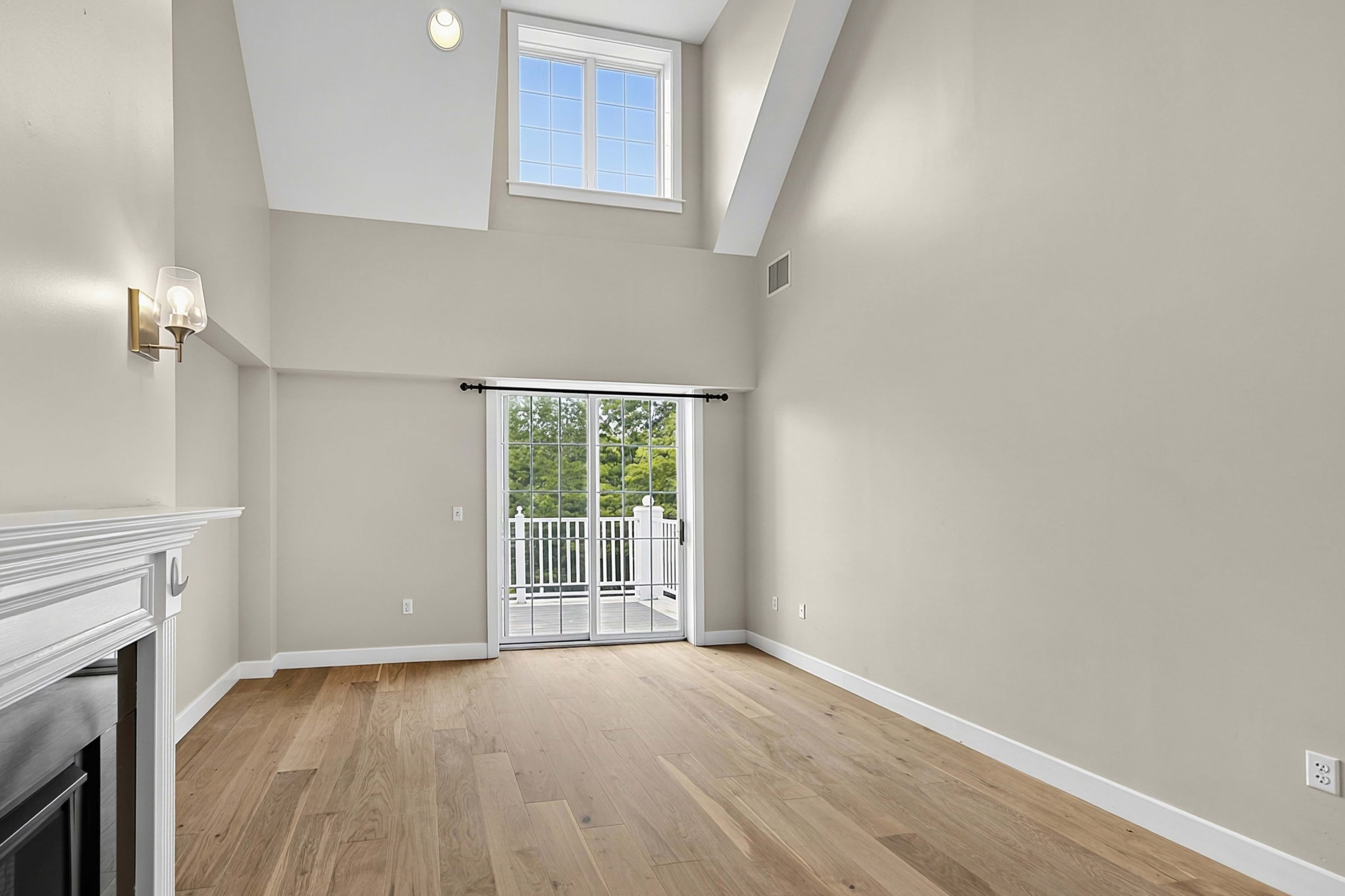 Wide view of the double-height living room and wood flooring