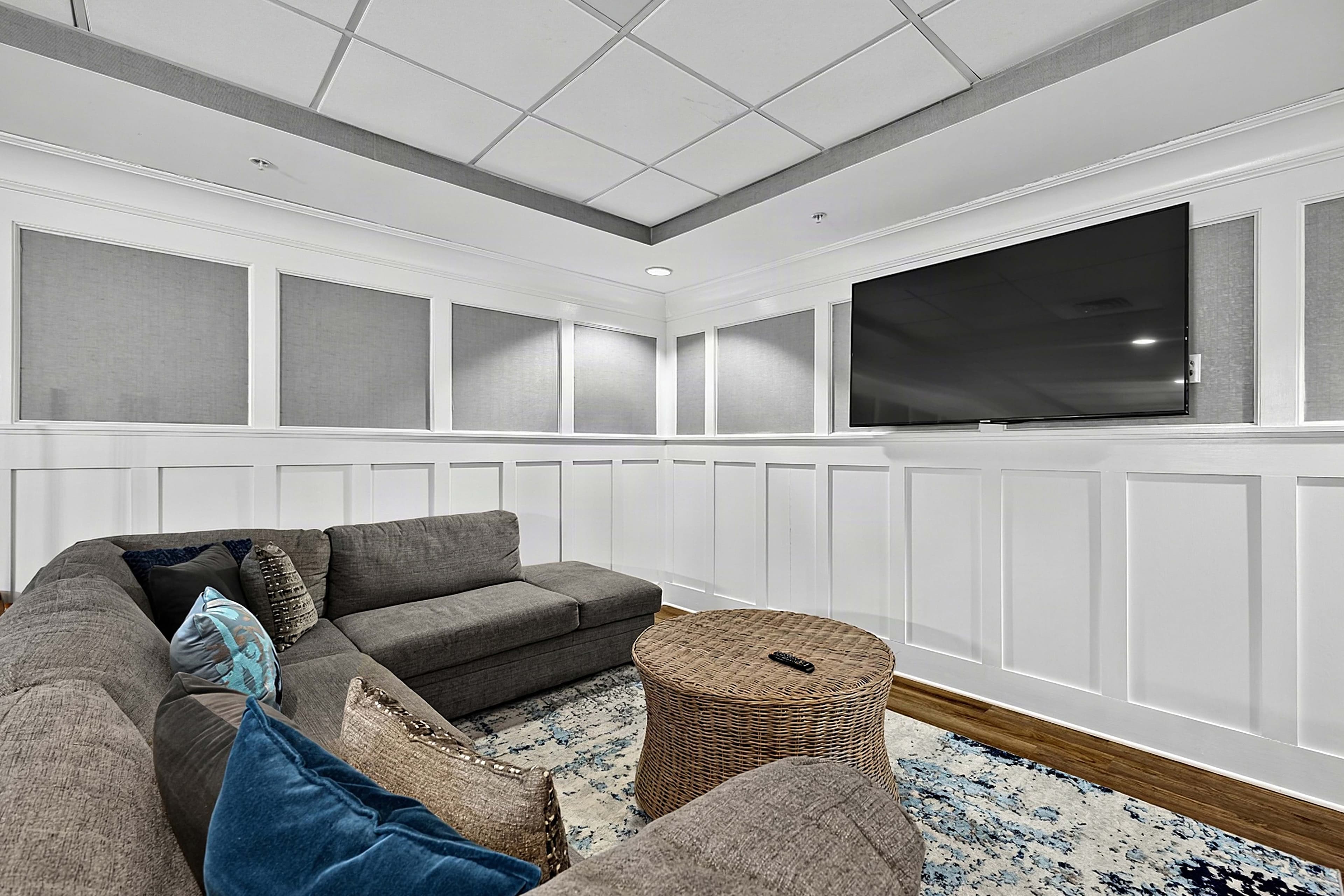 Sofa seating with blue cushions and round tables