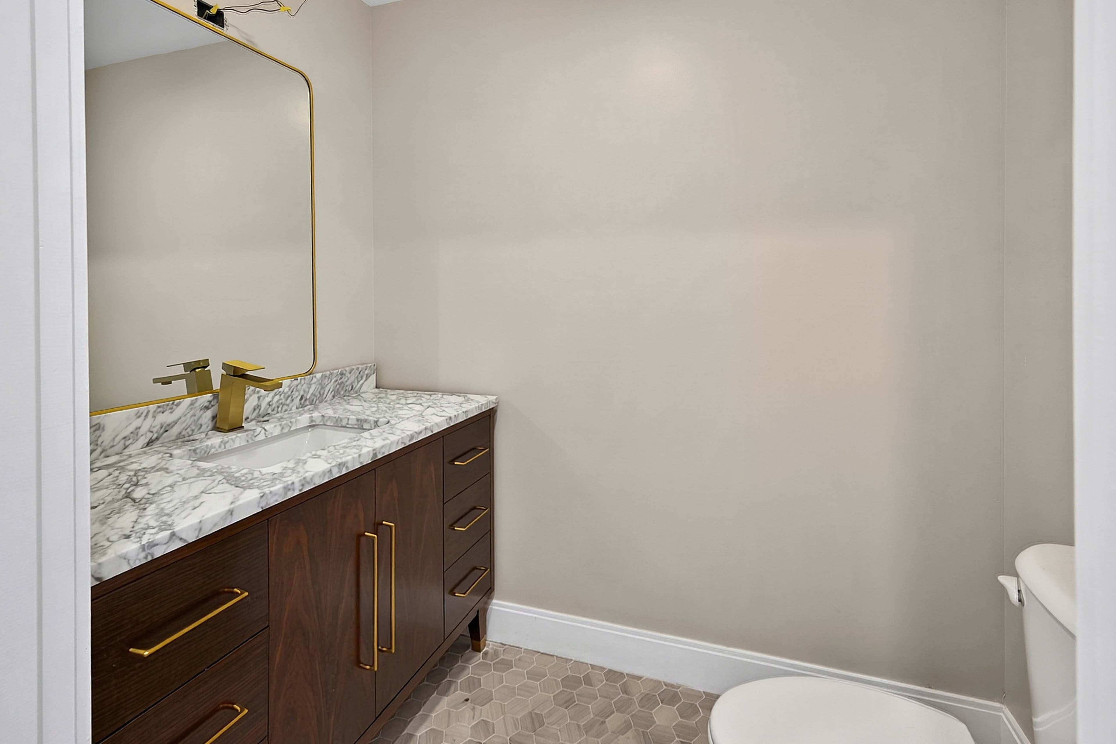 Powder room with a wood vanity and toilet