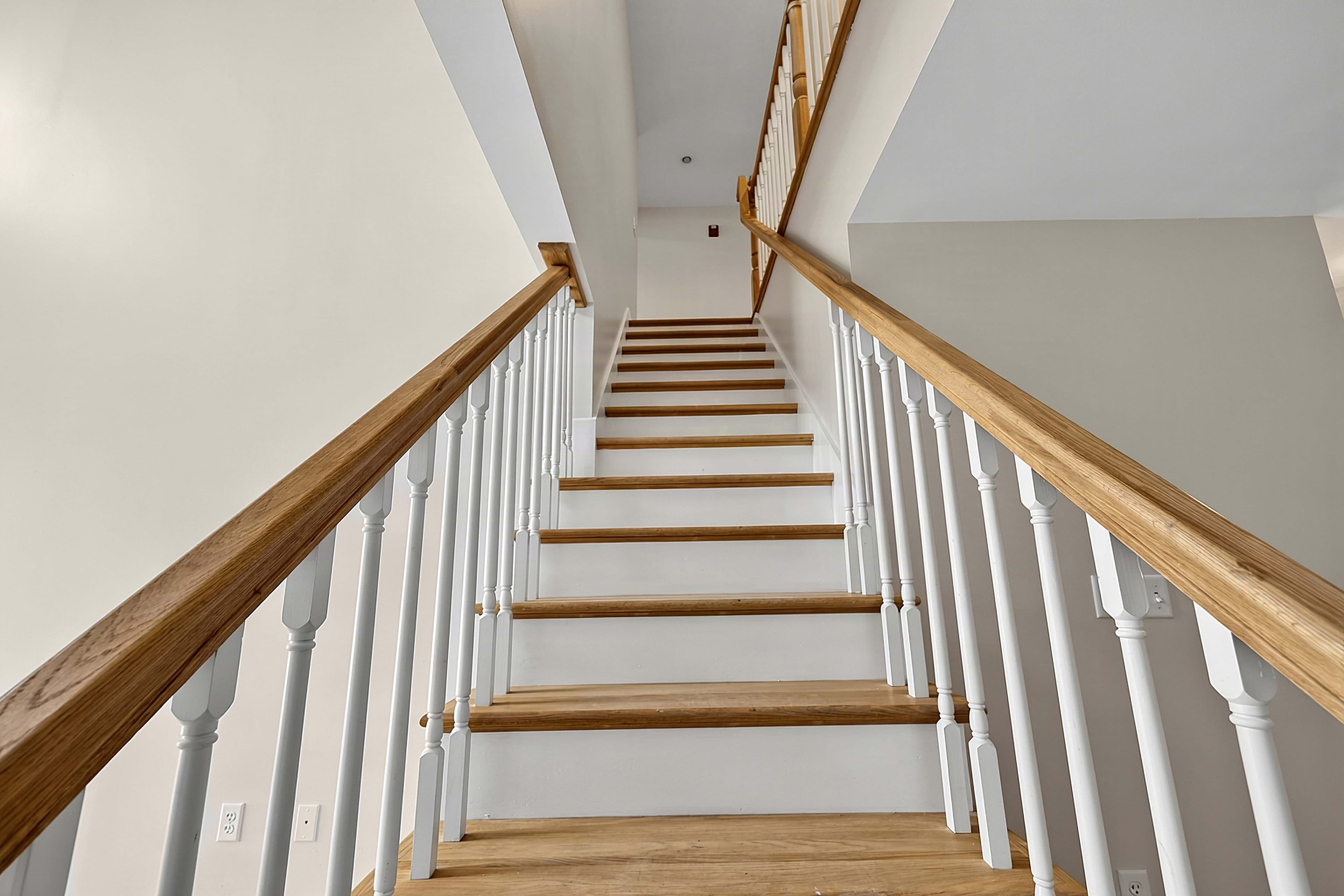 Wood staircase leading to the upper level of the apartment