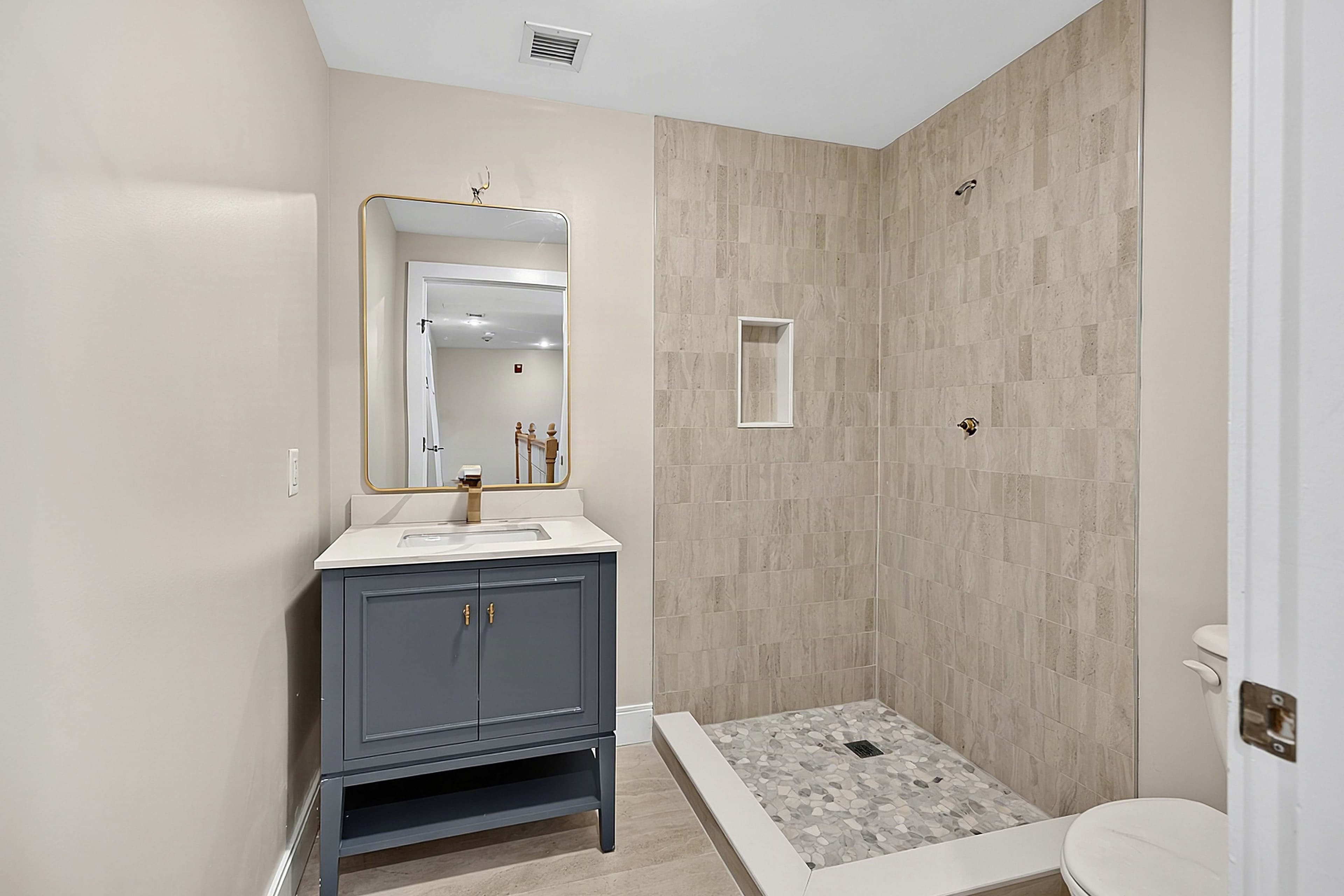 Renovated bathroom with a tiled walk-in shower