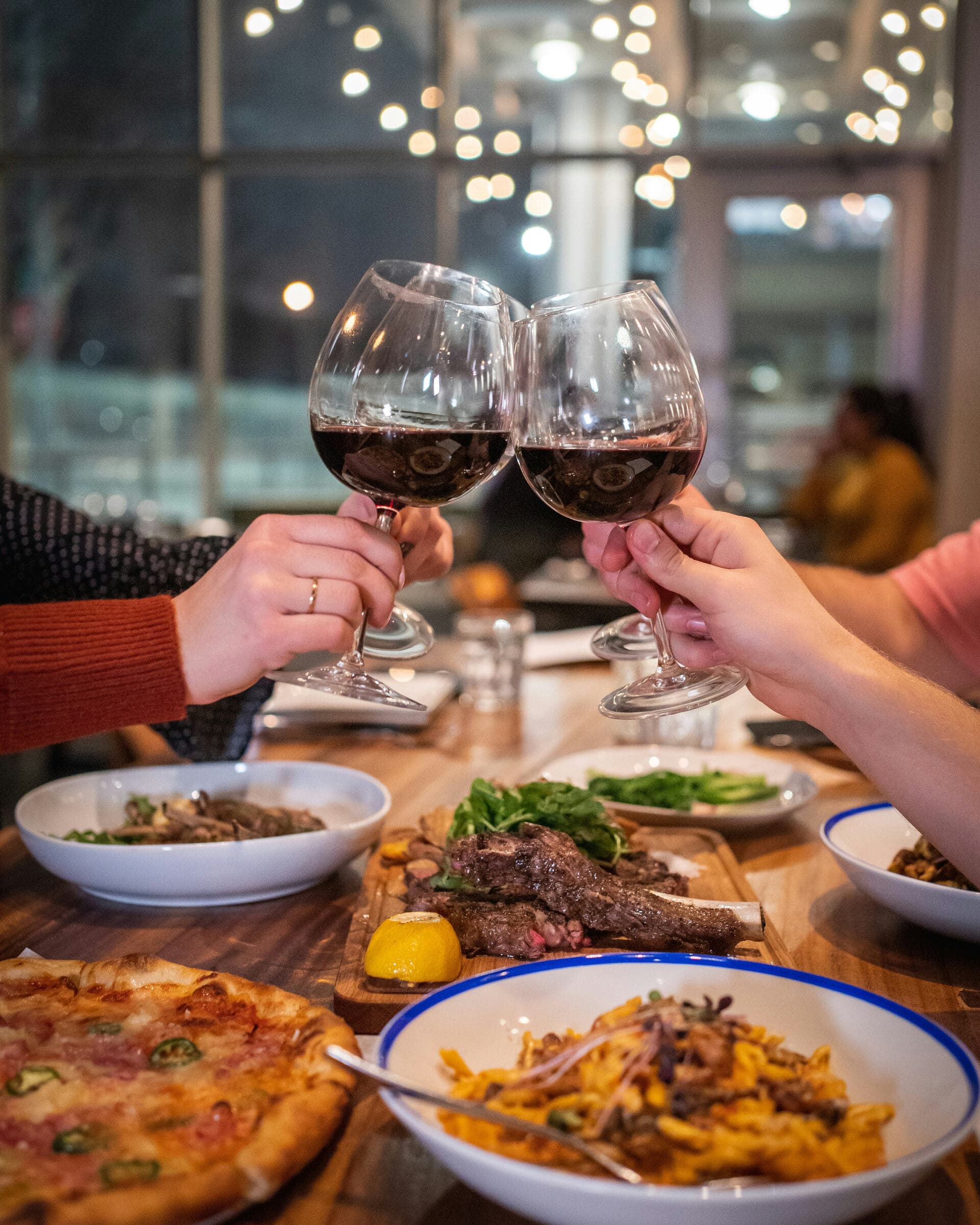 Friends sharing wine over dinner
